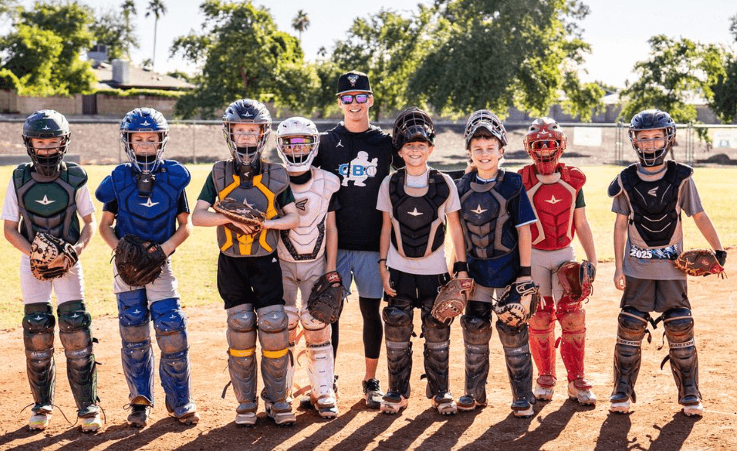 Coach Bernie with a group of young catchers at camp
