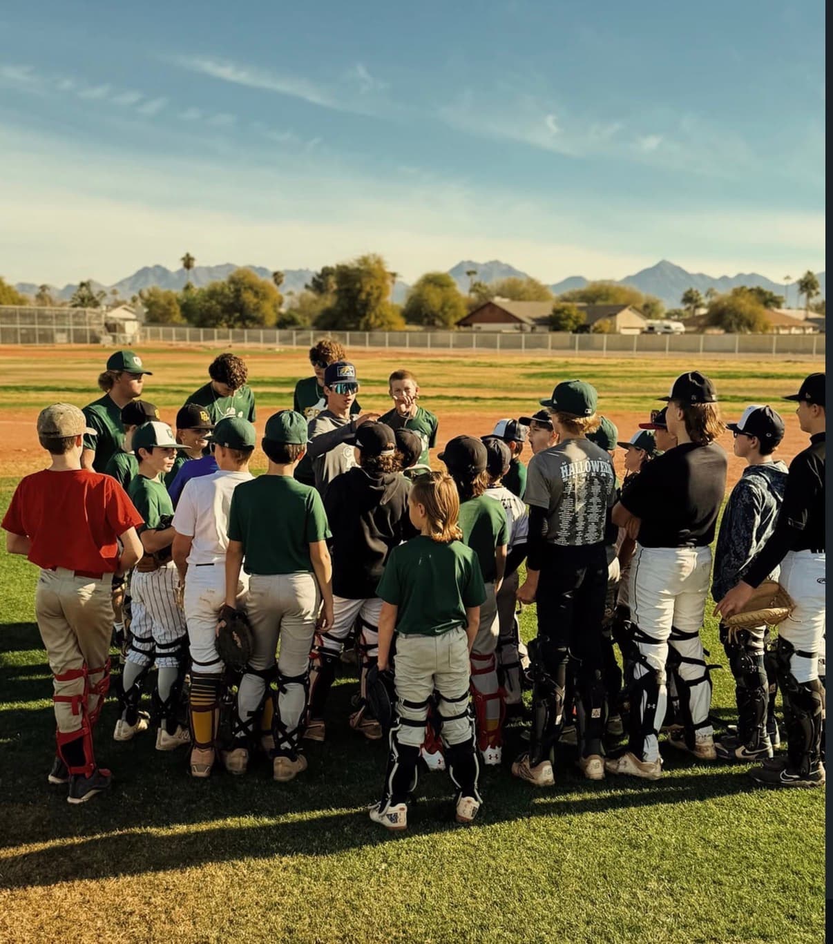 Coach Bernie teaching a group of catchers